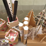 The Christmas collection made of cardboard by Lessmore, Design Giorgio Caporaso, includes trees and small gift items in Christmas colors
